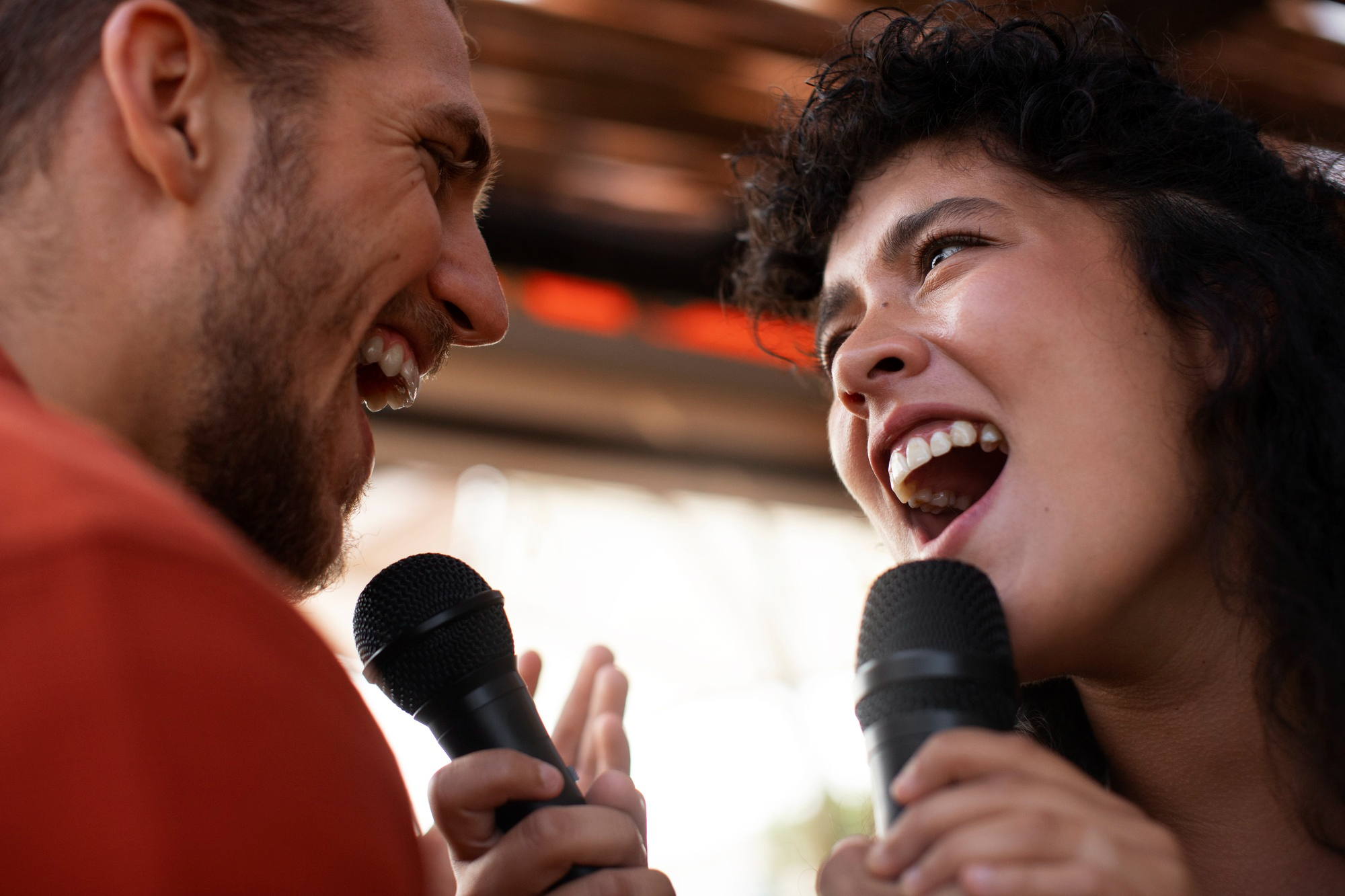 Two people singing passionately together, the energy LAMI Outreach CIC brings to communities across South Wales.